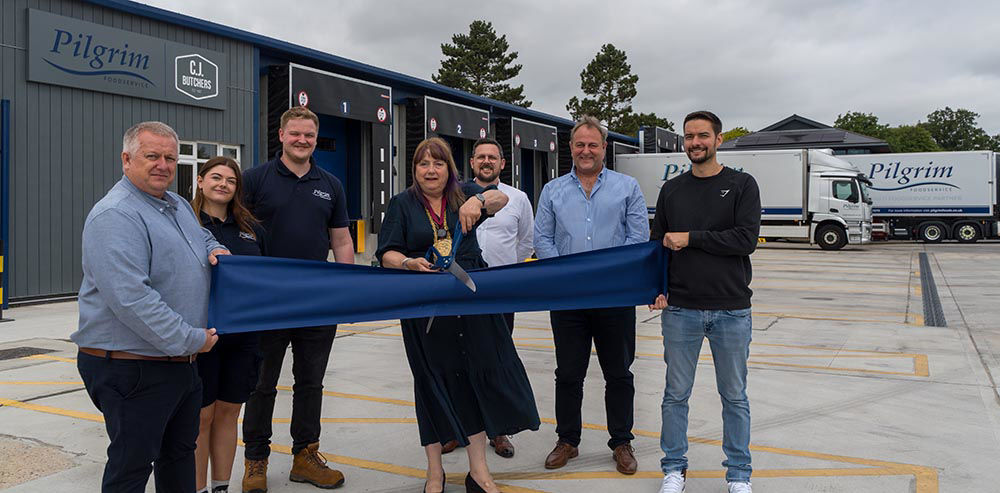 The team and mayor cutting the ribbon outside the Colchester depot